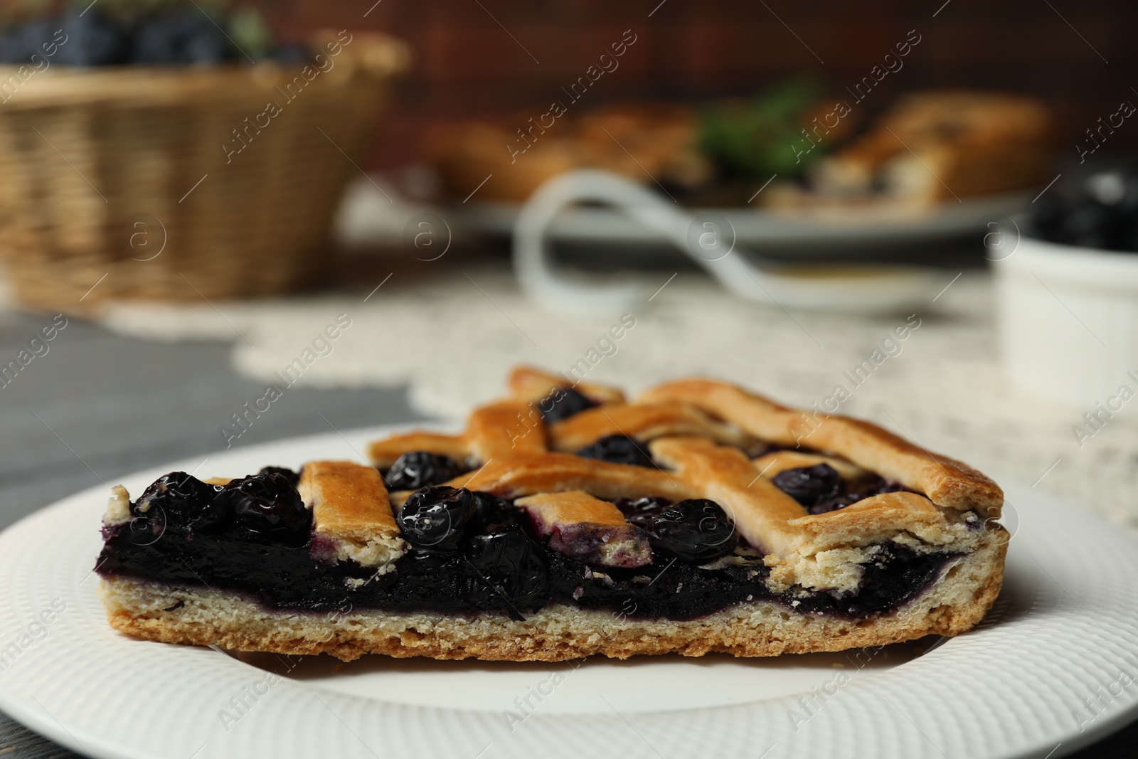 Photo of Piece of tasty homemade pie with blueberries on table, closeup