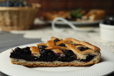 Photo of Piece of tasty homemade pie with blueberries on table, closeup