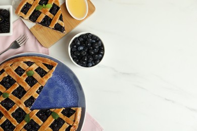 Photo of Tasty homemade pie with blueberries, honey and fork on white marble table, flat lay. Space for text