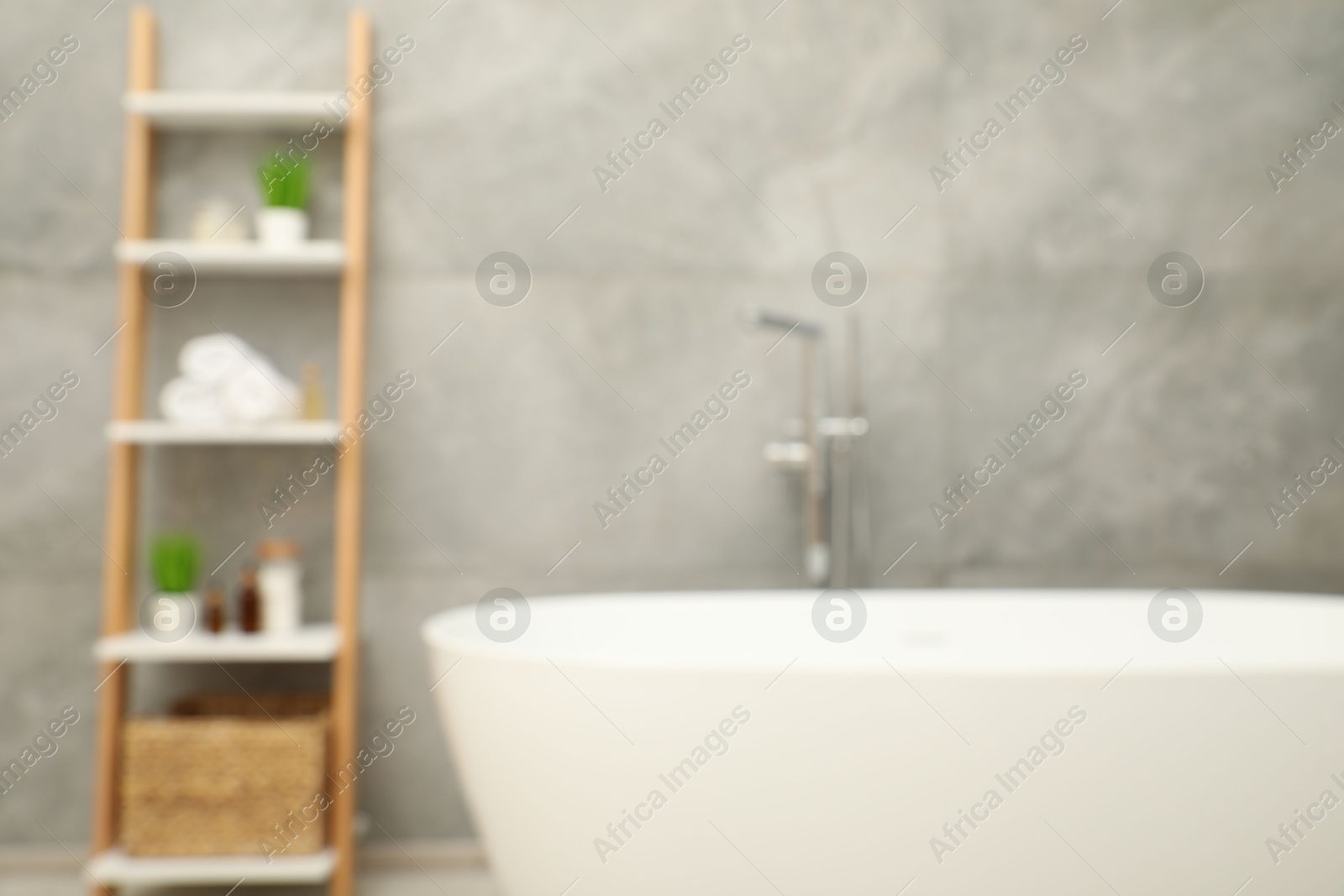 Photo of Blurred view of bath tub and shelf in bathroom