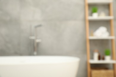 Photo of Blurred view of bath tub and shelf in bathroom