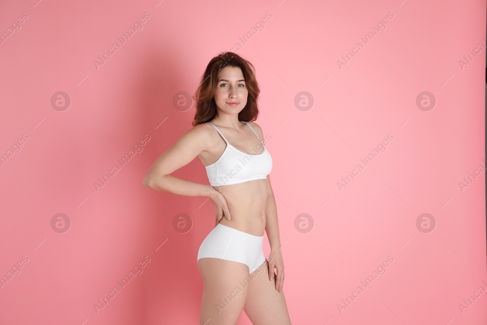 Photo of Woman with slim body posing on pink background