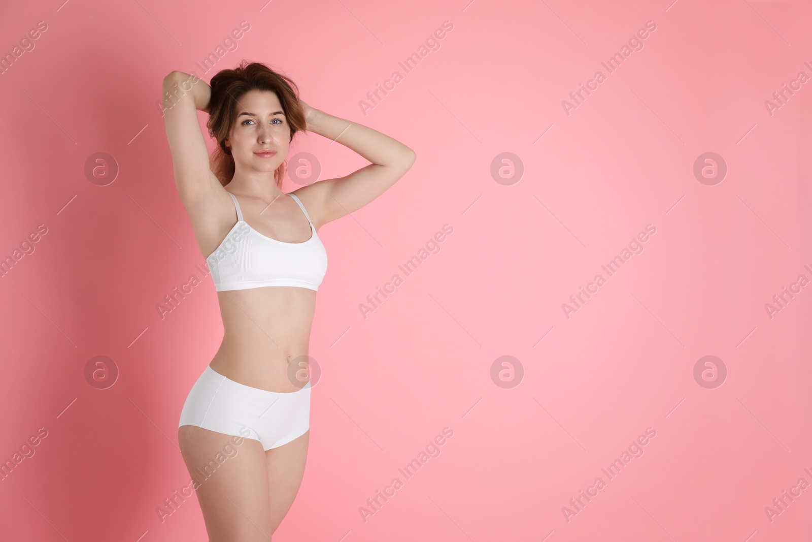 Photo of Woman with slim body posing on pink background, space for text