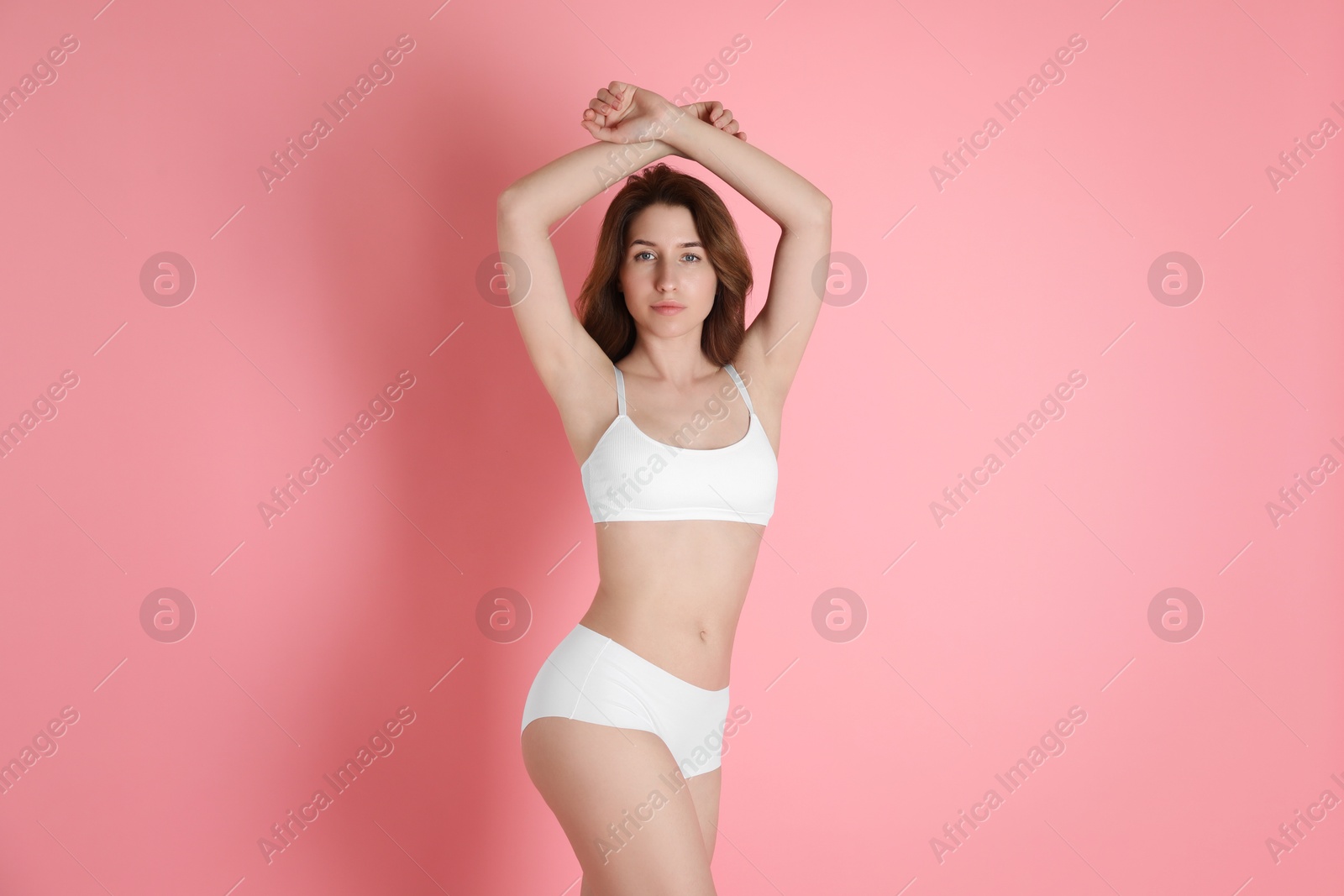 Photo of Woman with slim body posing on pink background