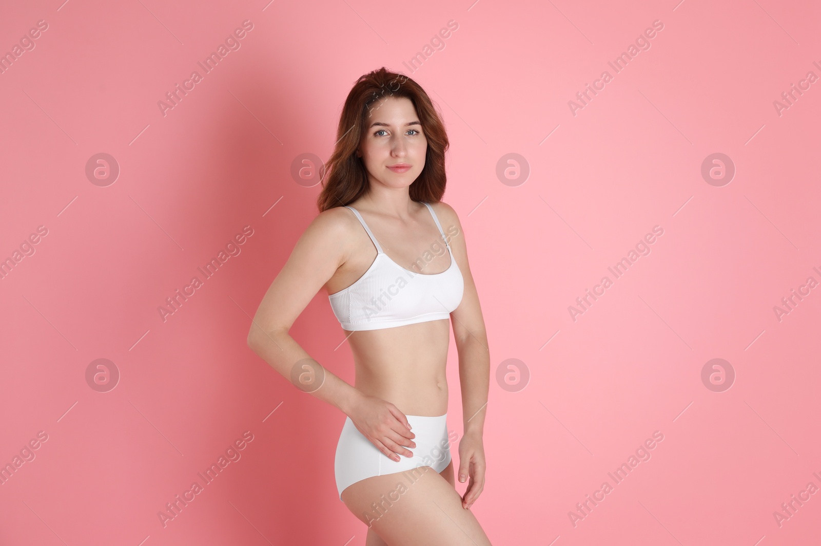 Photo of Woman with slim body posing on pink background