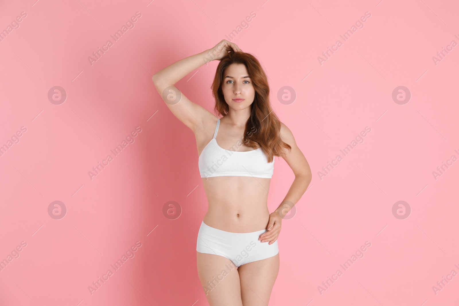 Photo of Woman with slim body posing on pink background