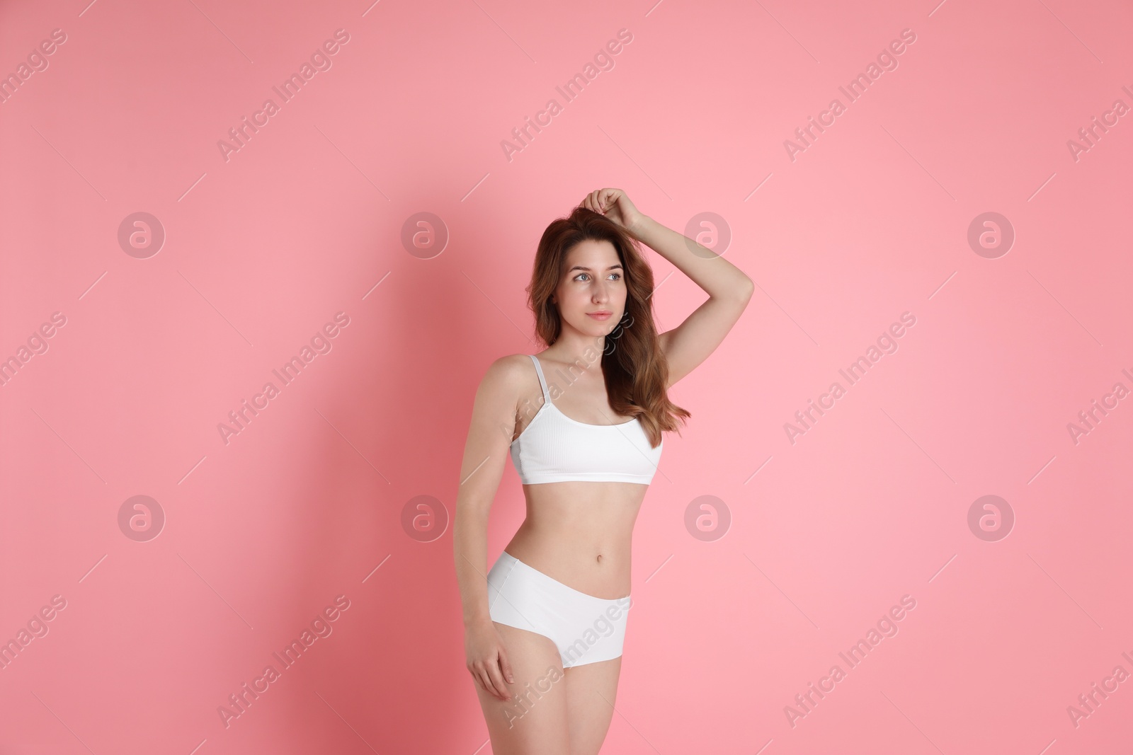 Photo of Woman with slim body posing on pink background