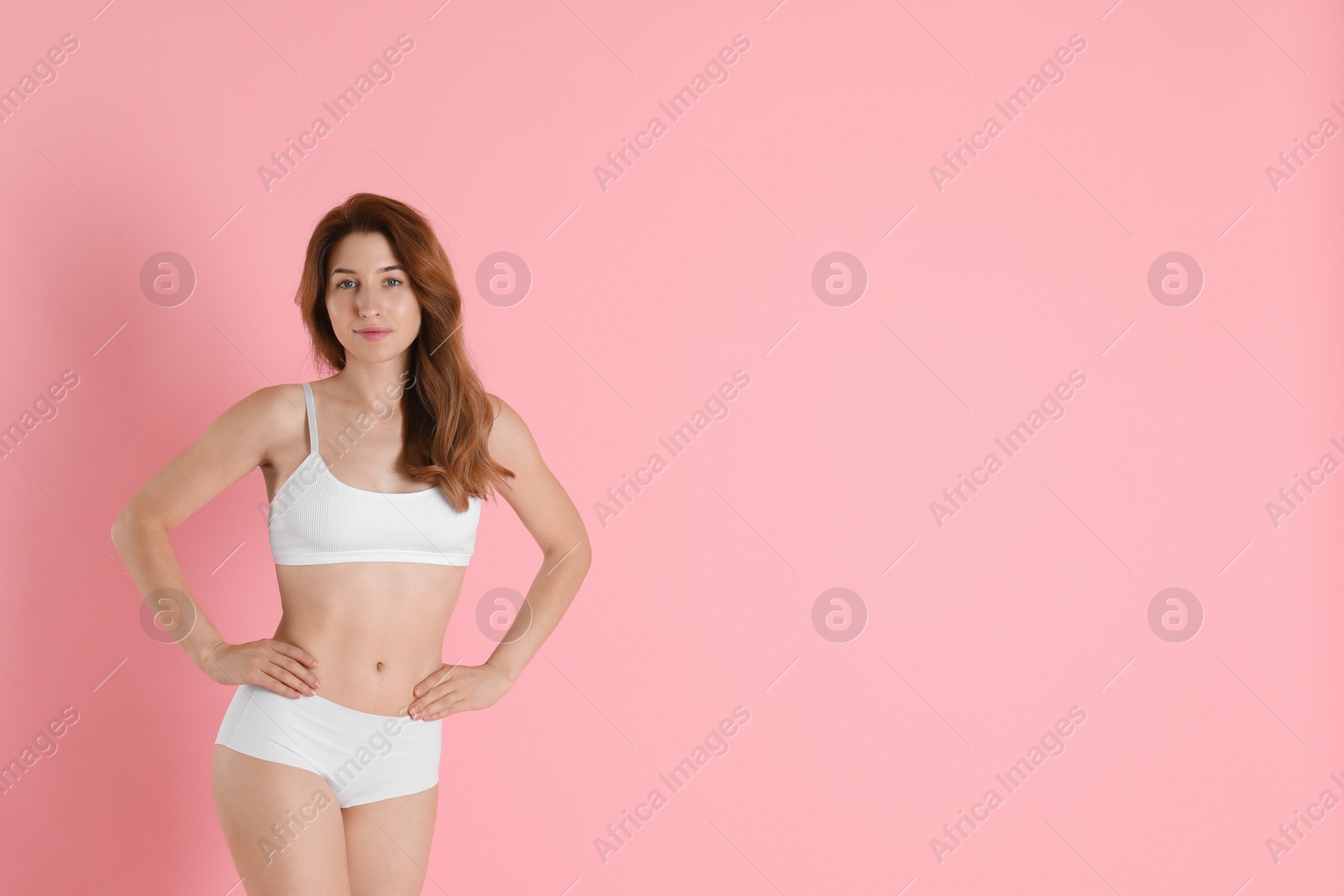 Photo of Woman with slim body posing on pink background, space for text