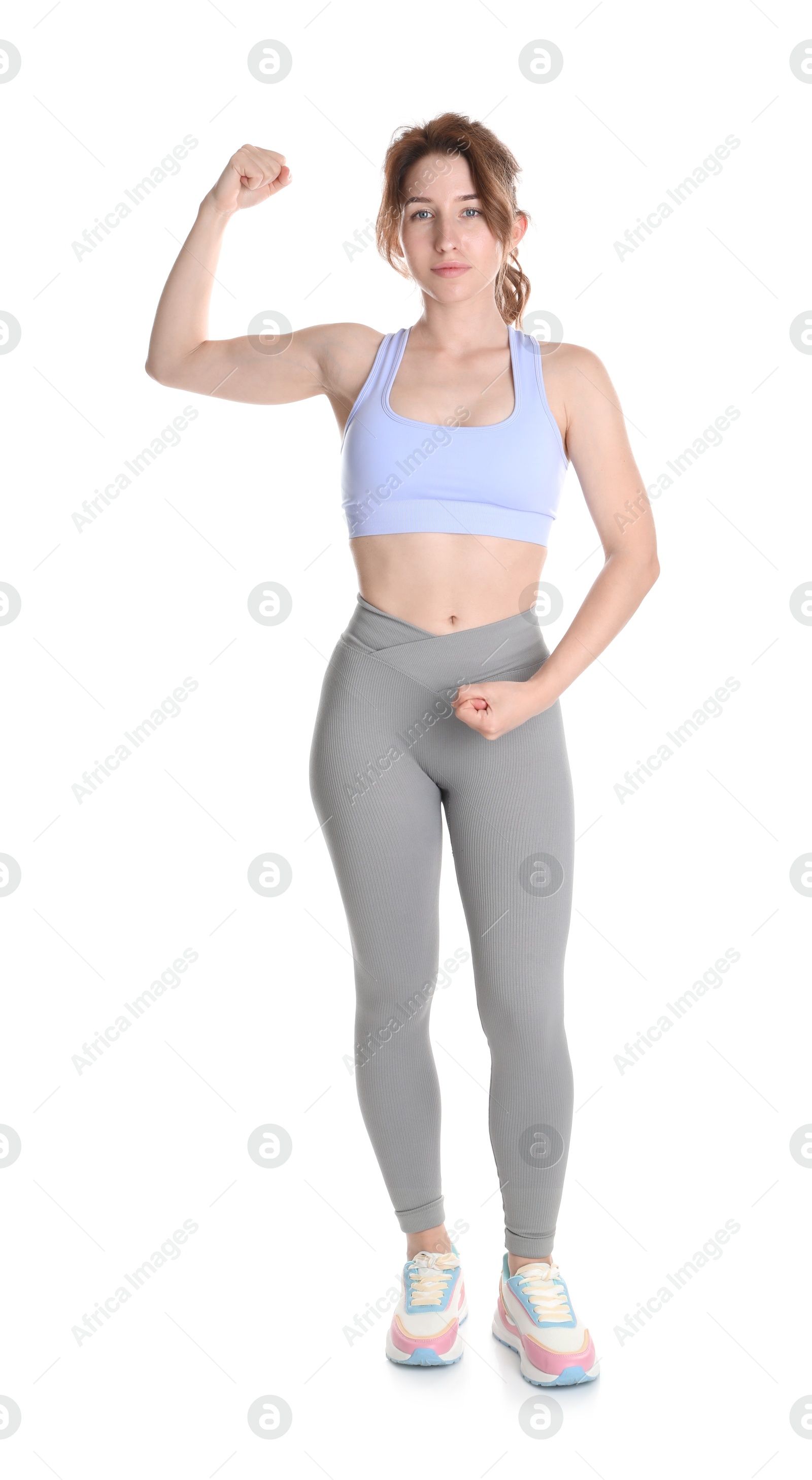 Photo of Woman with slim body showing muscles on white background