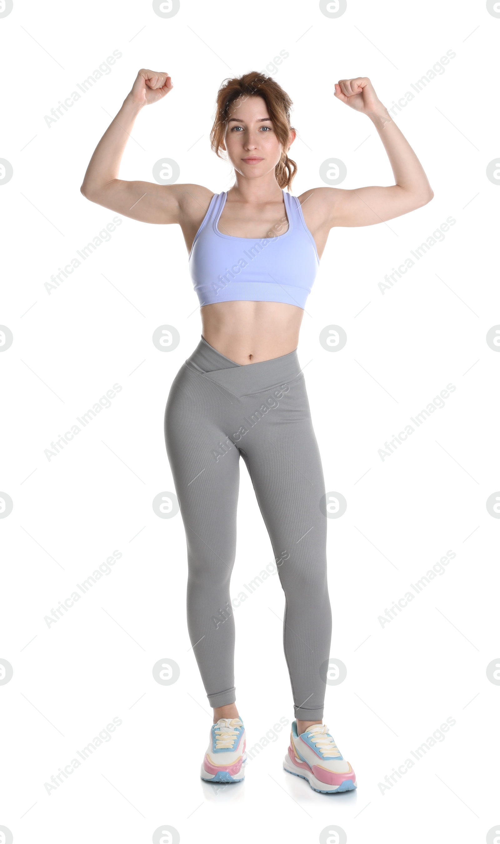 Photo of Woman with slim body showing muscles on white background