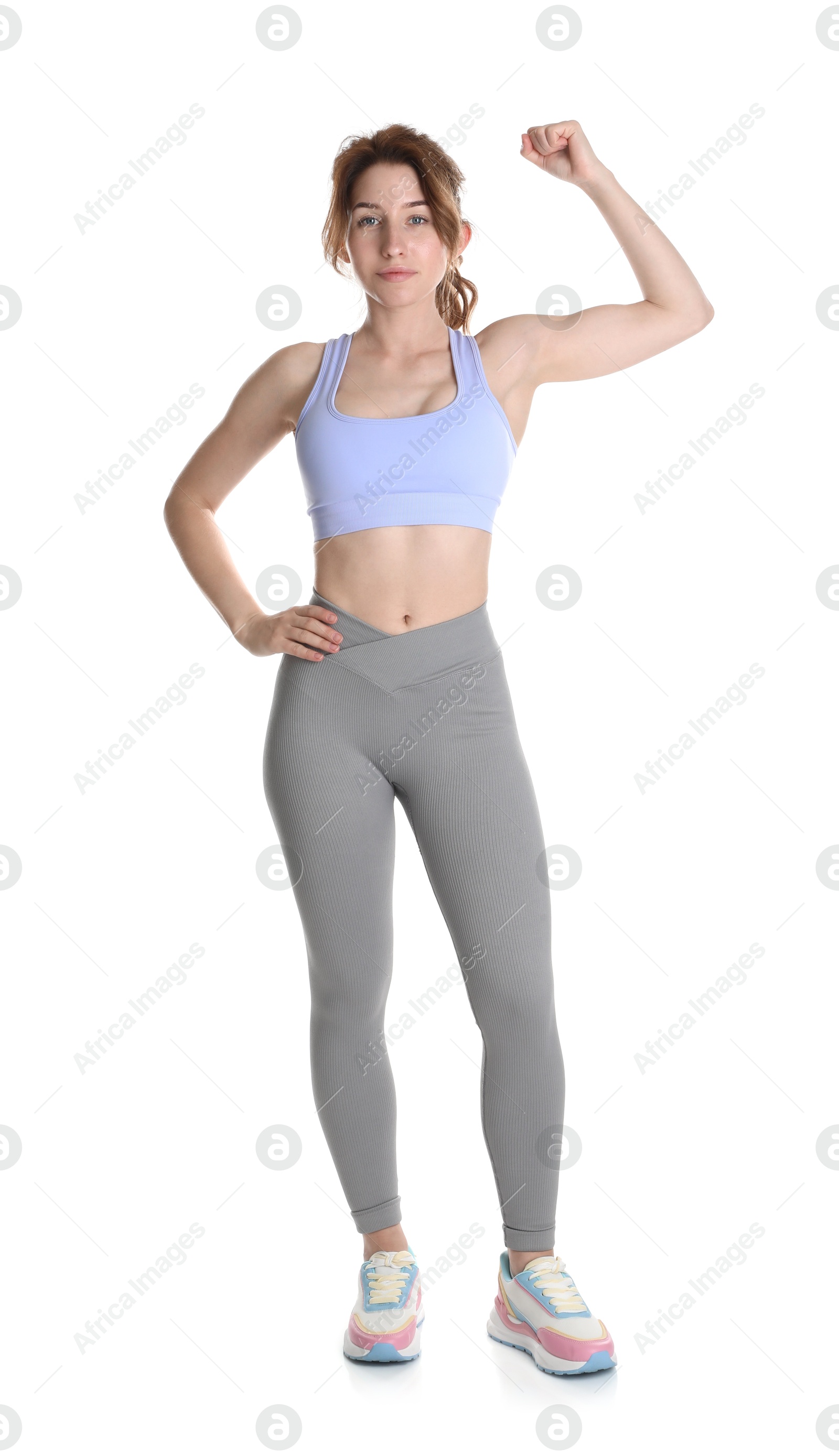 Photo of Woman with slim body showing muscles on white background