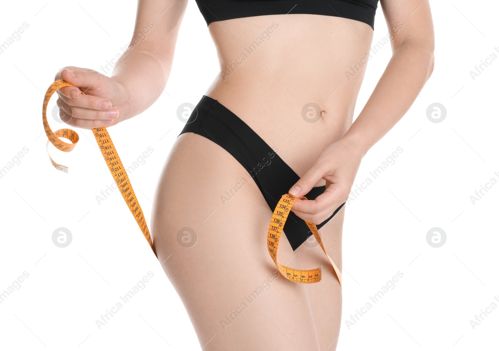 Photo of Woman with measuring tape showing her slim body against white background, closeup