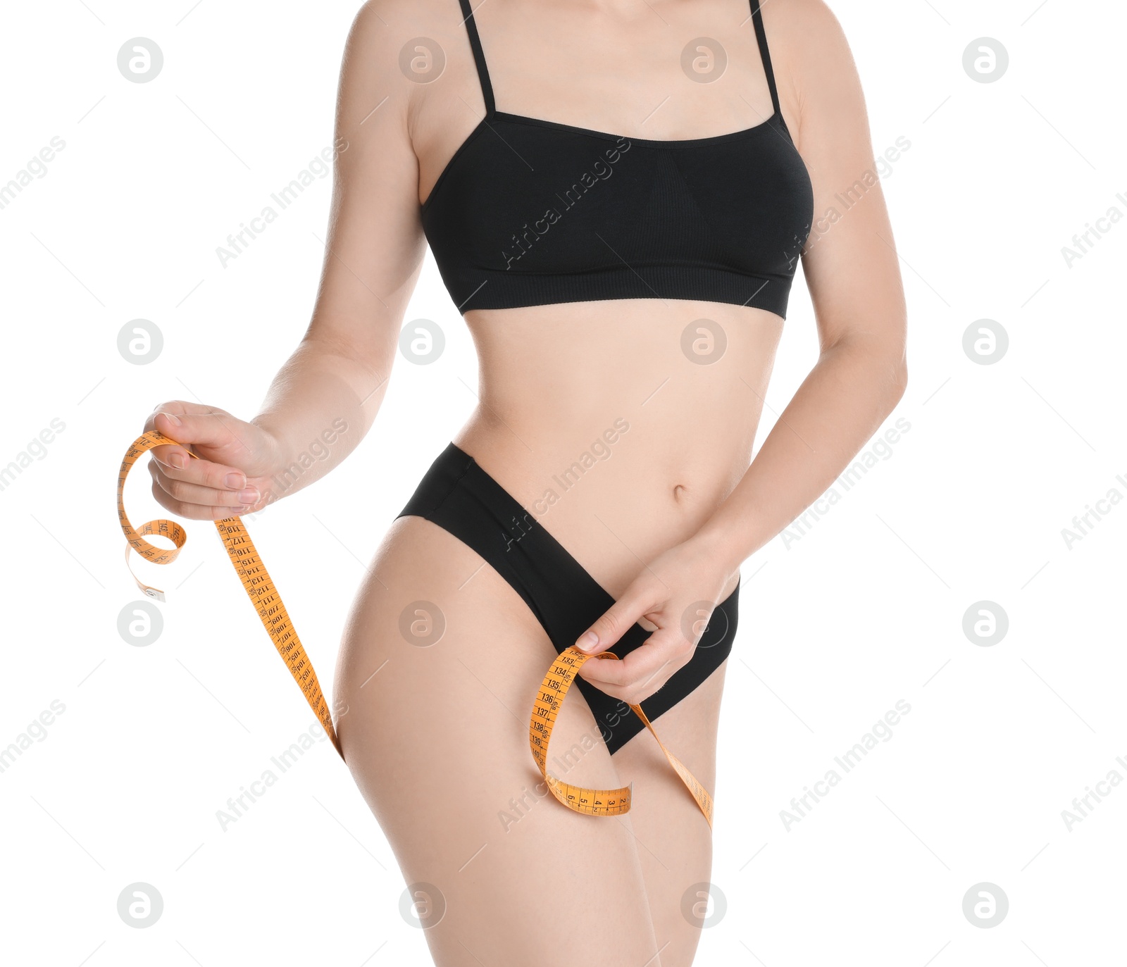 Photo of Woman with measuring tape showing her slim body against white background, closeup