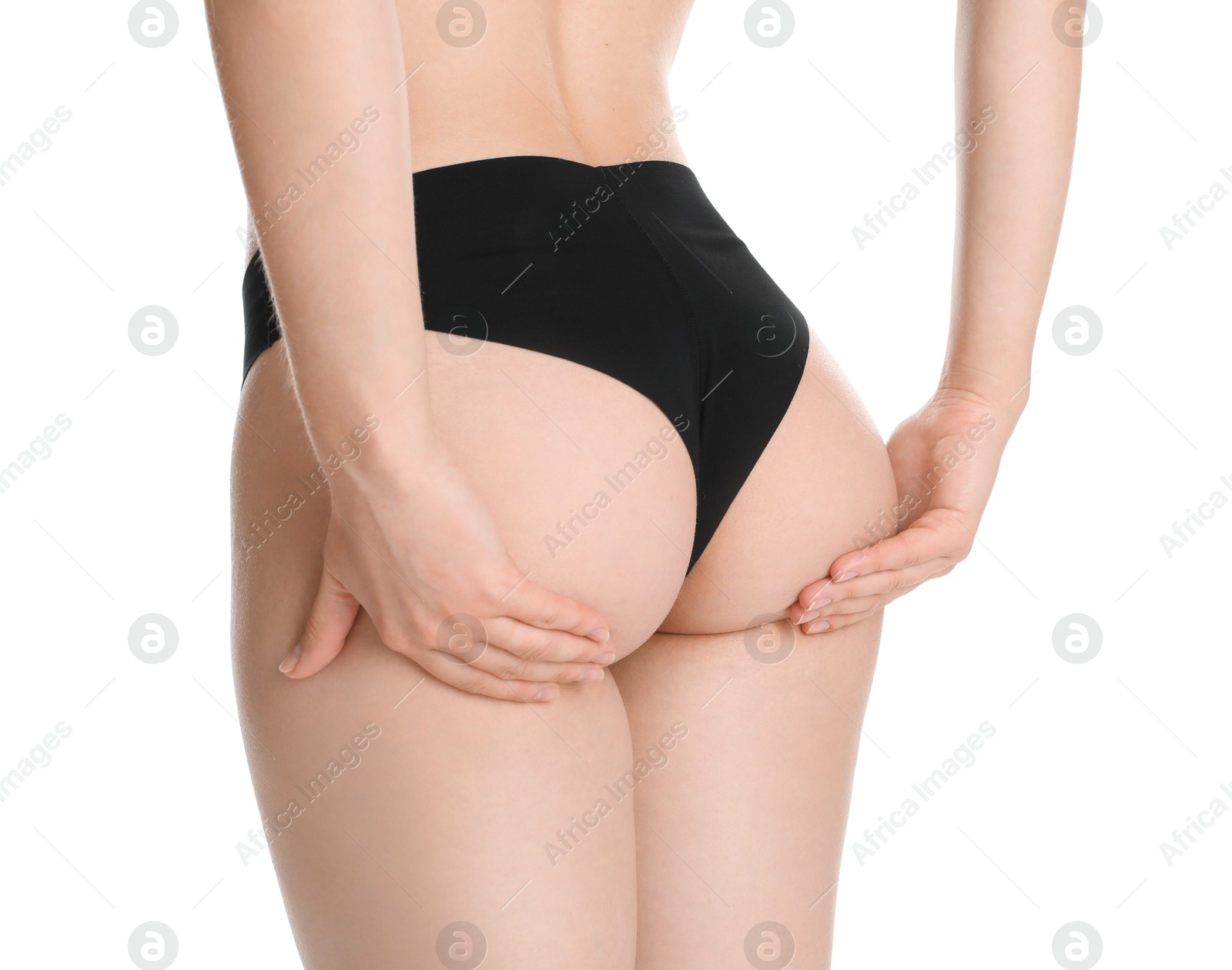 Photo of Woman in black panties showing her slim body on white background, closeup