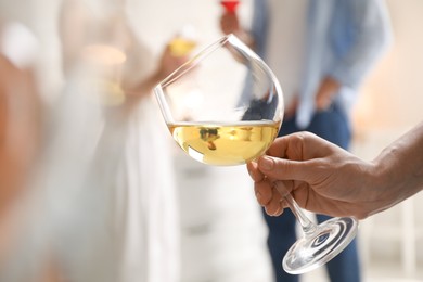 Photo of Woman with glass of wine indoors, selective focus