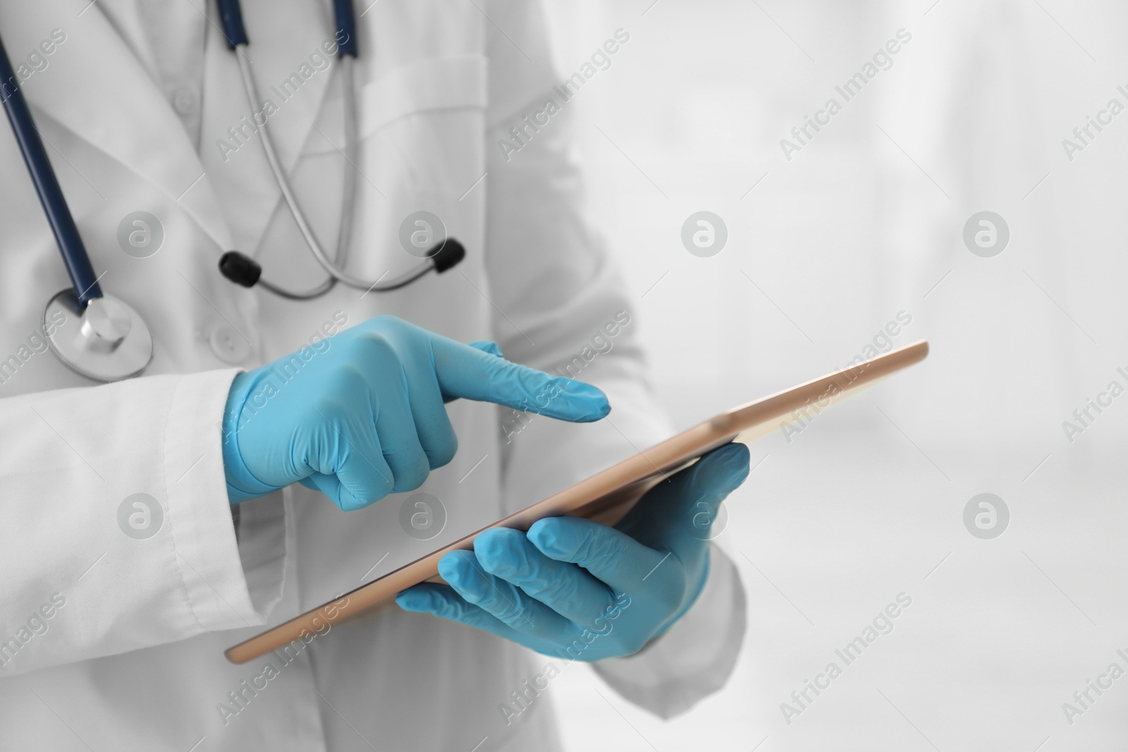 Photo of Doctor with tablet in clinic, closeup view