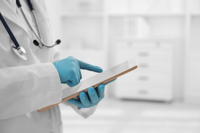 Photo of Doctor with tablet in clinic, closeup view