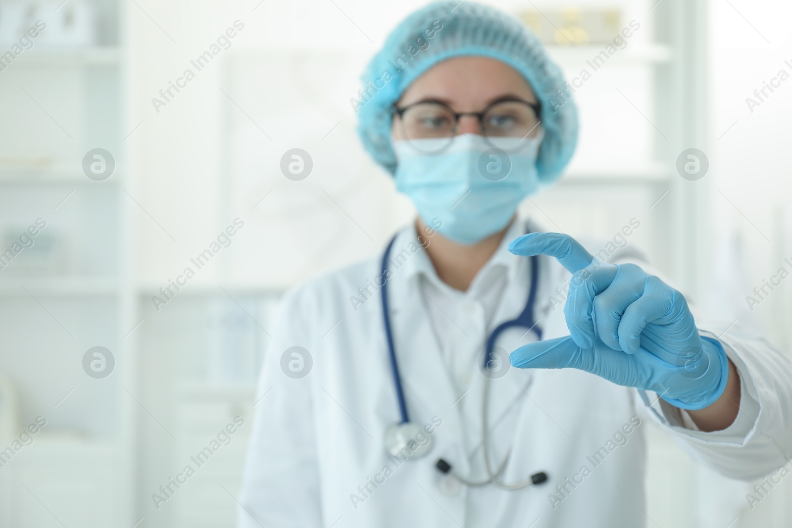 Photo of Doctor holding something in clinic, selective focus. Space for text