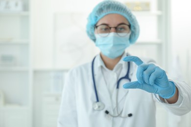 Photo of Doctor holding something in clinic, selective focus. Space for text