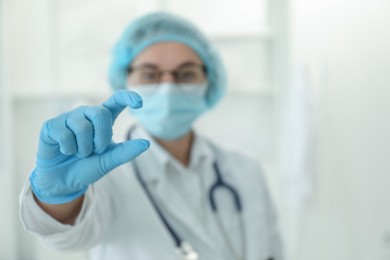 Photo of Doctor holding something in clinic, selective focus. Space for text