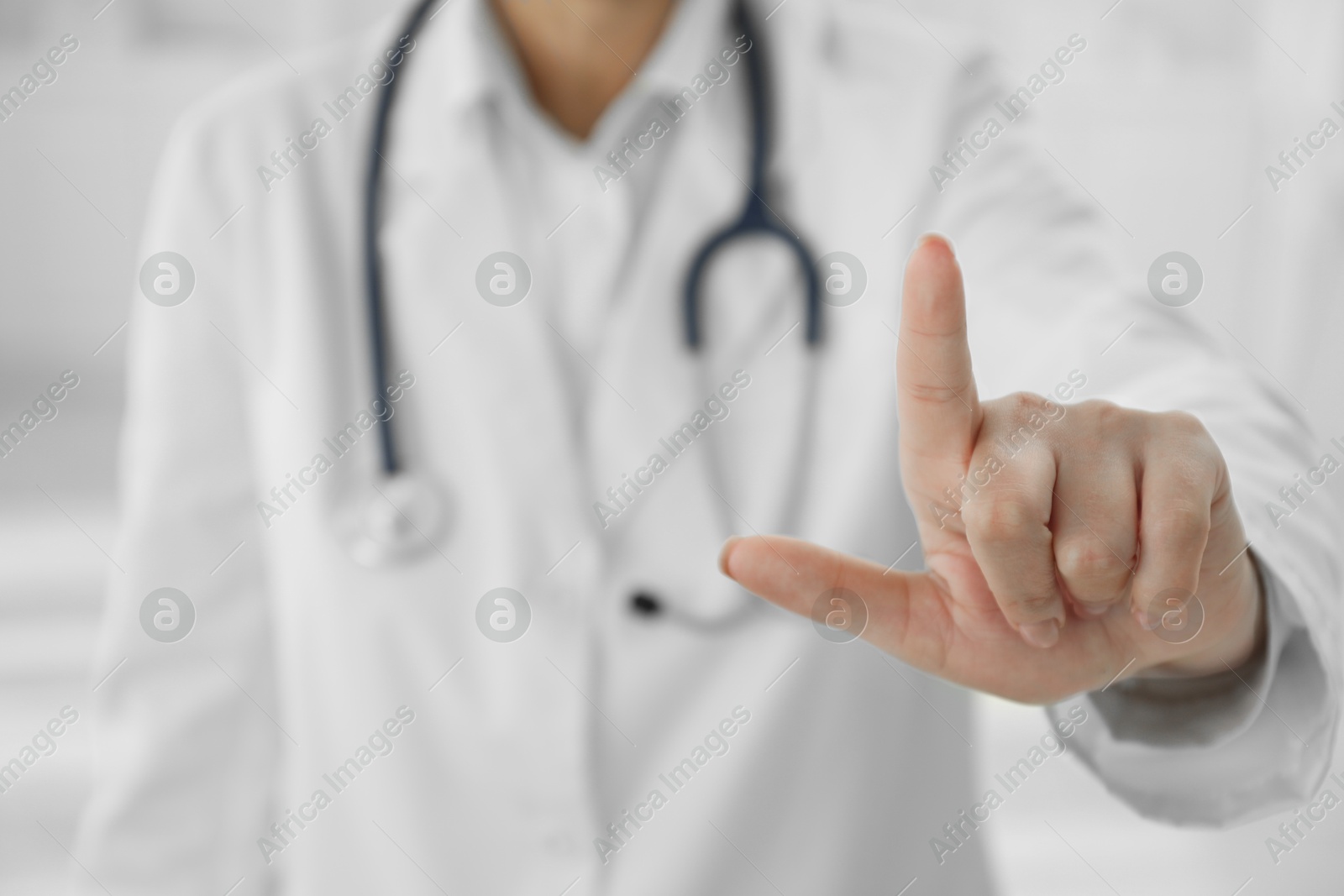 Photo of Doctor pointing at something in clinic, closeup view. Space for text