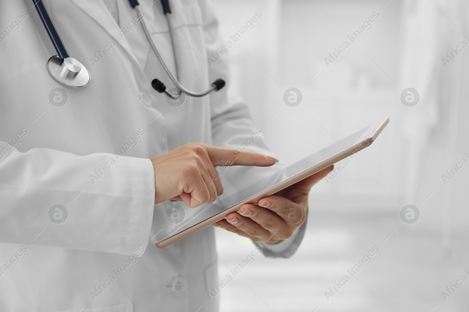 Photo of Doctor with tablet in clinic, closeup view