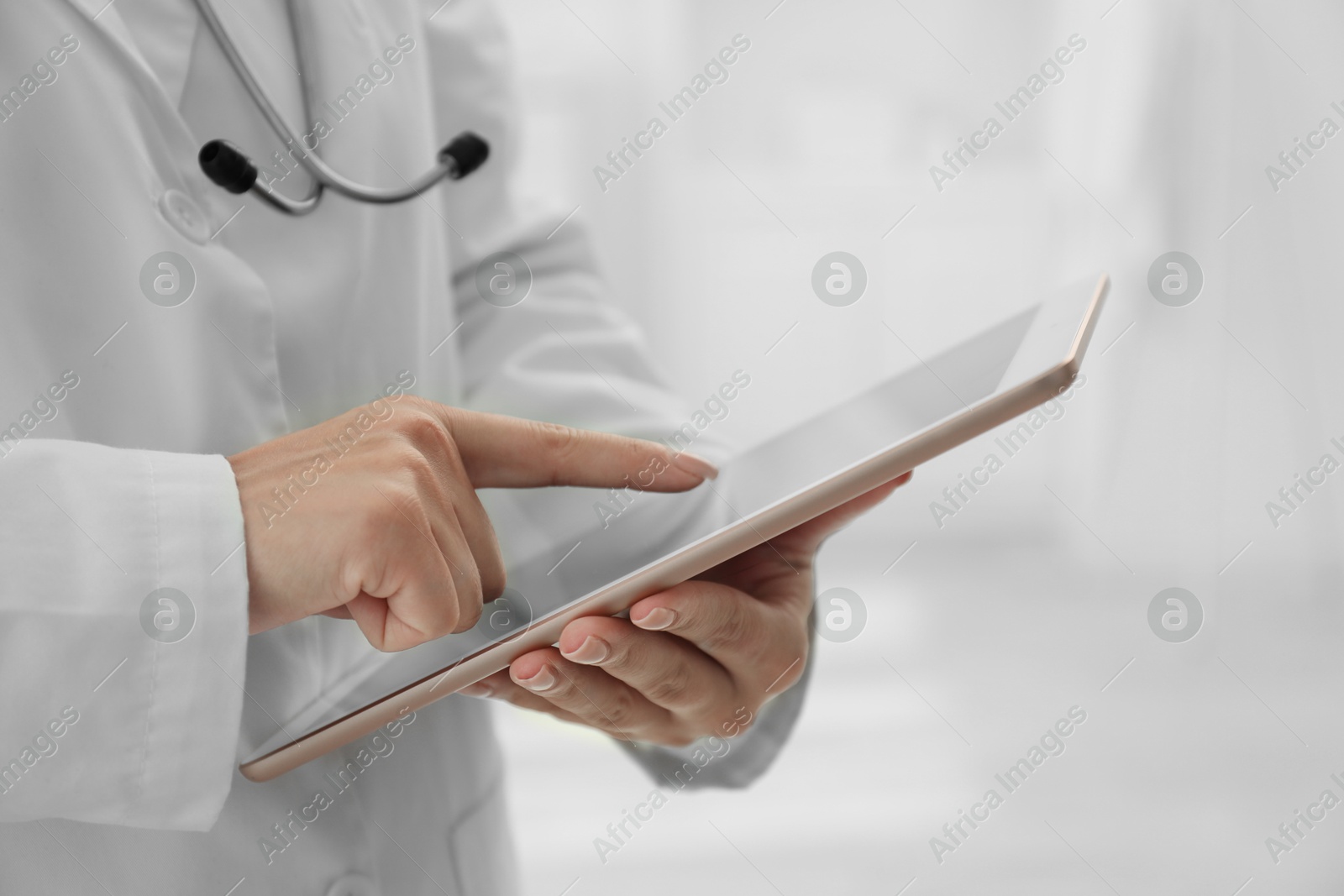 Photo of Doctor with tablet in clinic, closeup view