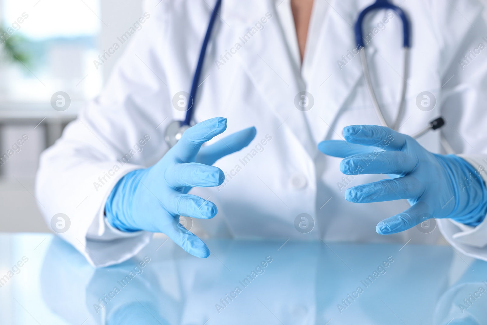 Photo of Doctor holding something at table in clinic, closeup