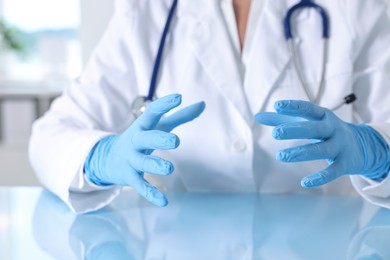 Doctor holding something at table in clinic, closeup