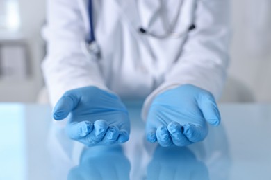 Photo of Doctor holding something at table in clinic, closeup