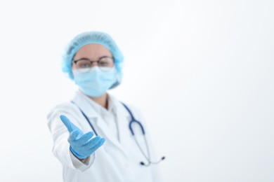 Photo of Doctor holding something on white background, selective focus