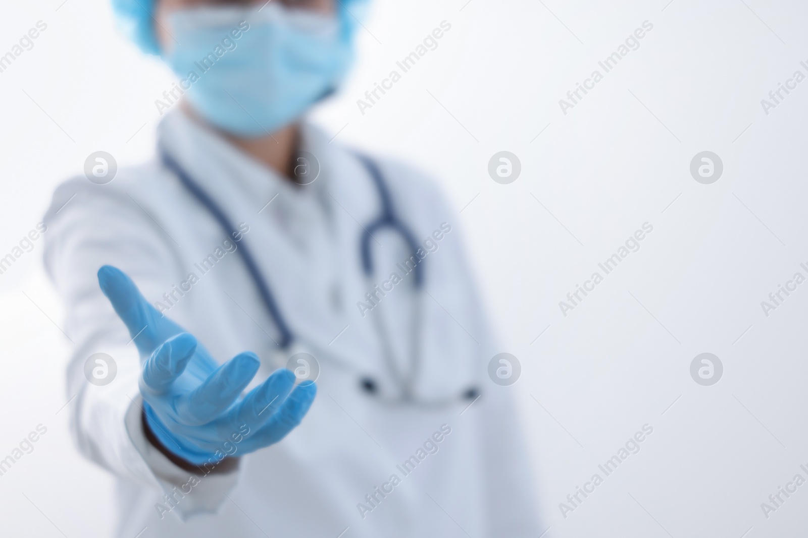 Photo of Doctor holding something on white background, selective focus