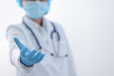 Photo of Doctor holding something on white background, selective focus