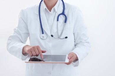 Photo of Doctor with tablet on white background, closeup view