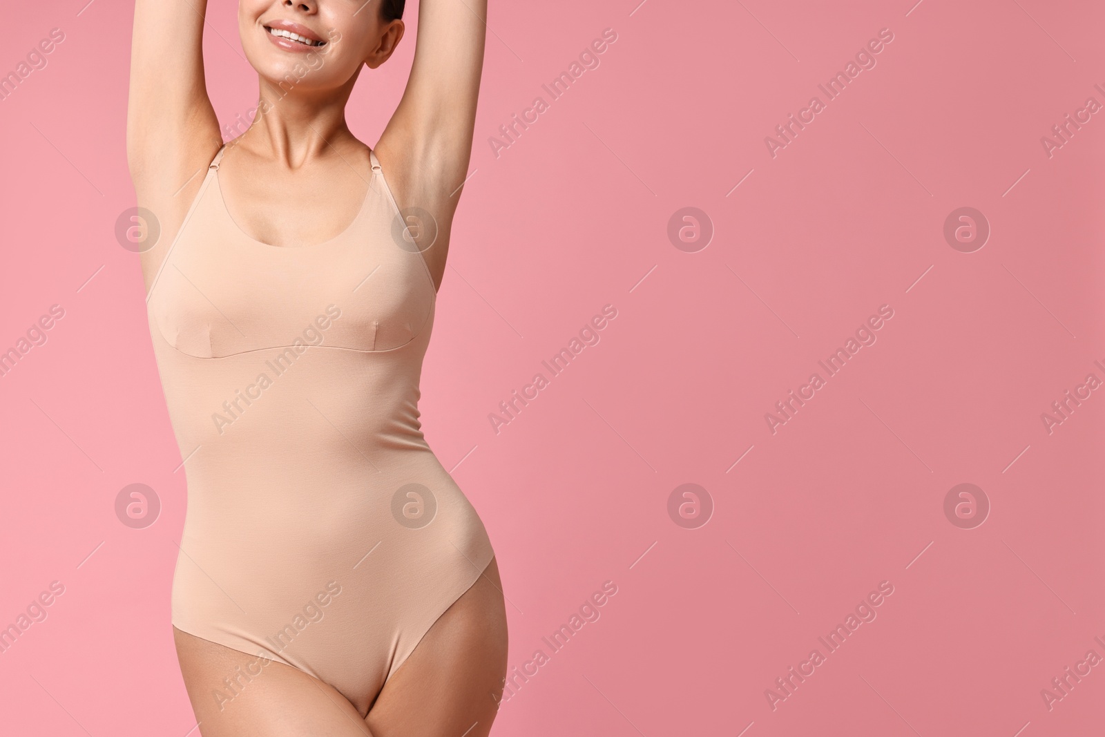 Photo of Smiling woman with perfect skin on pink background, closeup and space for text. Body care