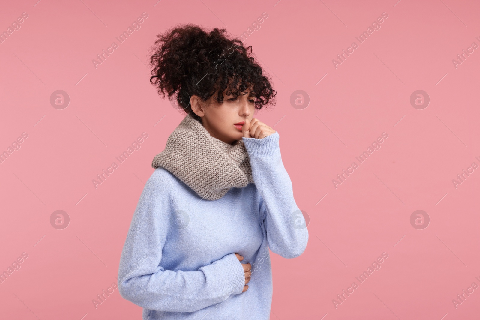 Photo of Cold symptom. Young woman suffering from illness on pink background