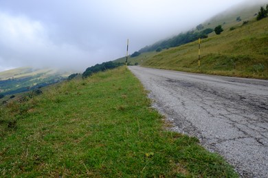 Picturesque view of green forest and road in mountains