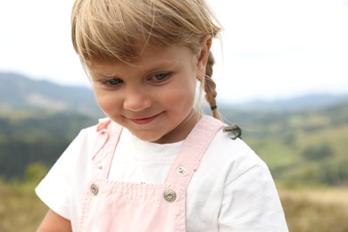 Photo of Cute little girl with lizard on shoulder outdoors. Enjoying beautiful nature