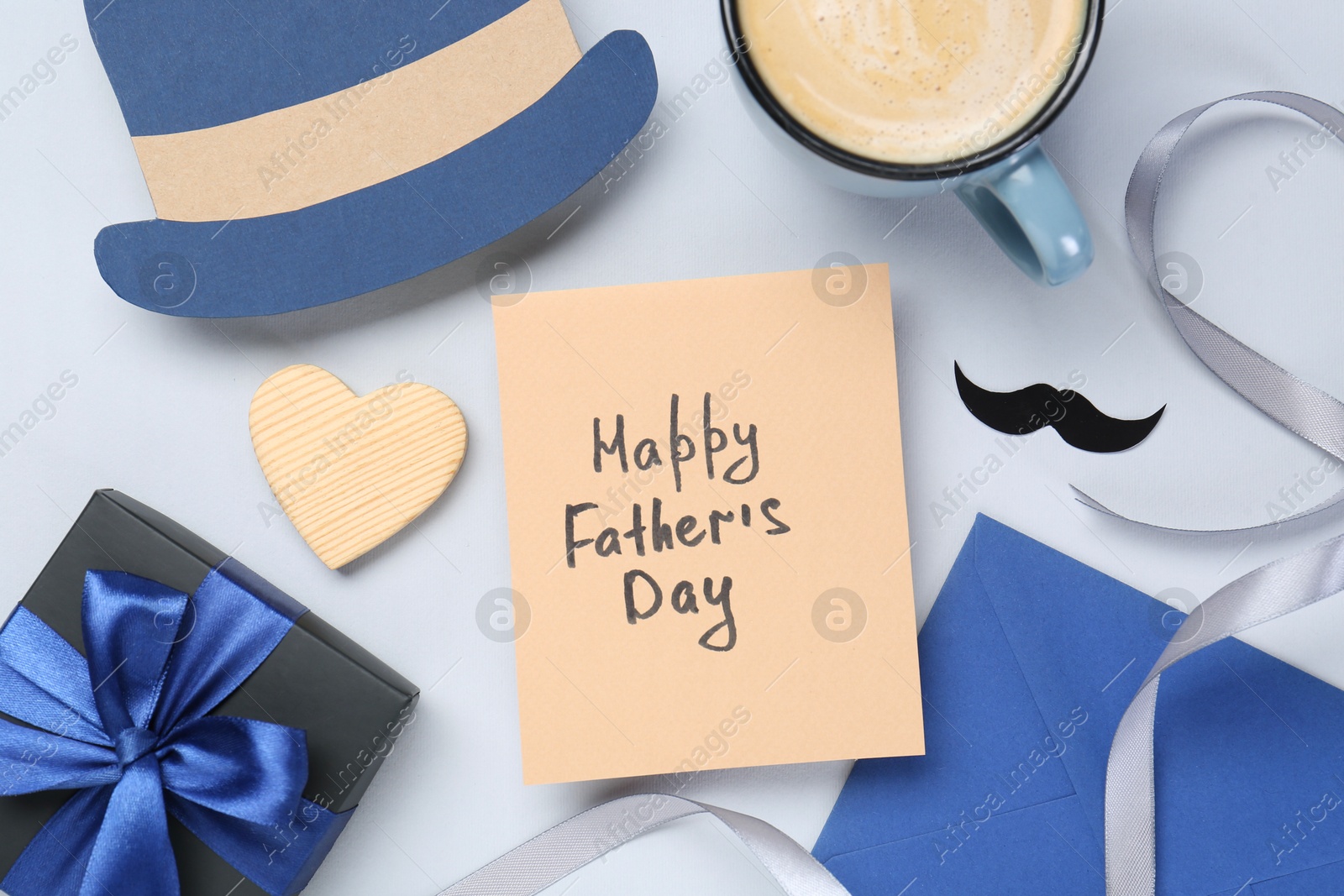 Photo of Greeting card with phrase Happy Father's Day, coffee, gift, paper hat and moustache on light background, flat lay