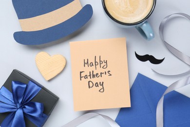 Photo of Greeting card with phrase Happy Father's Day, coffee, gift, paper hat and moustache on light background, flat lay