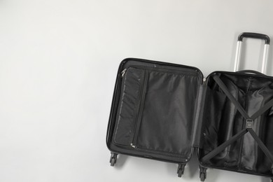 Open empty suitcase on light grey background, top view. Space for text