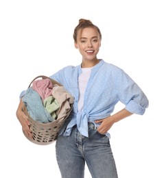 Photo of Happy young housewife with basket full of laundry on white background