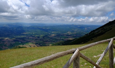 Photo of Picturesque view of green forest and wooden fence in mountains