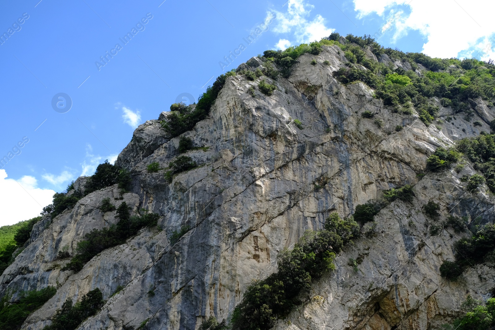 Photo of Picturesque view of rocky cliff against blue sky