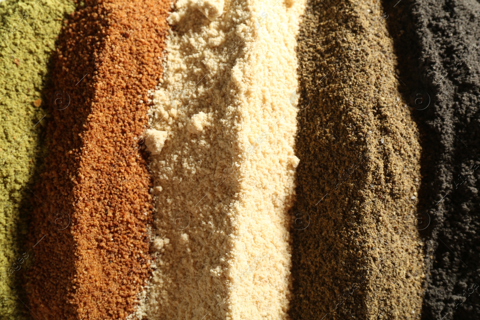 Photo of Different superfood powders as background, closeup view