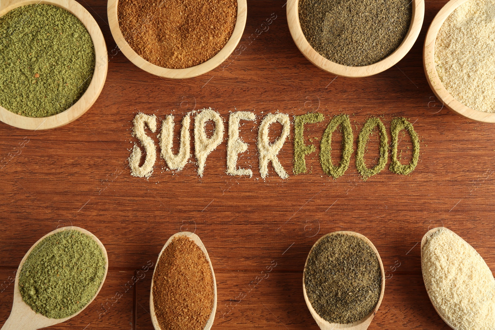 Photo of Word Superfood and different healthy powders on wooden table, flat lay