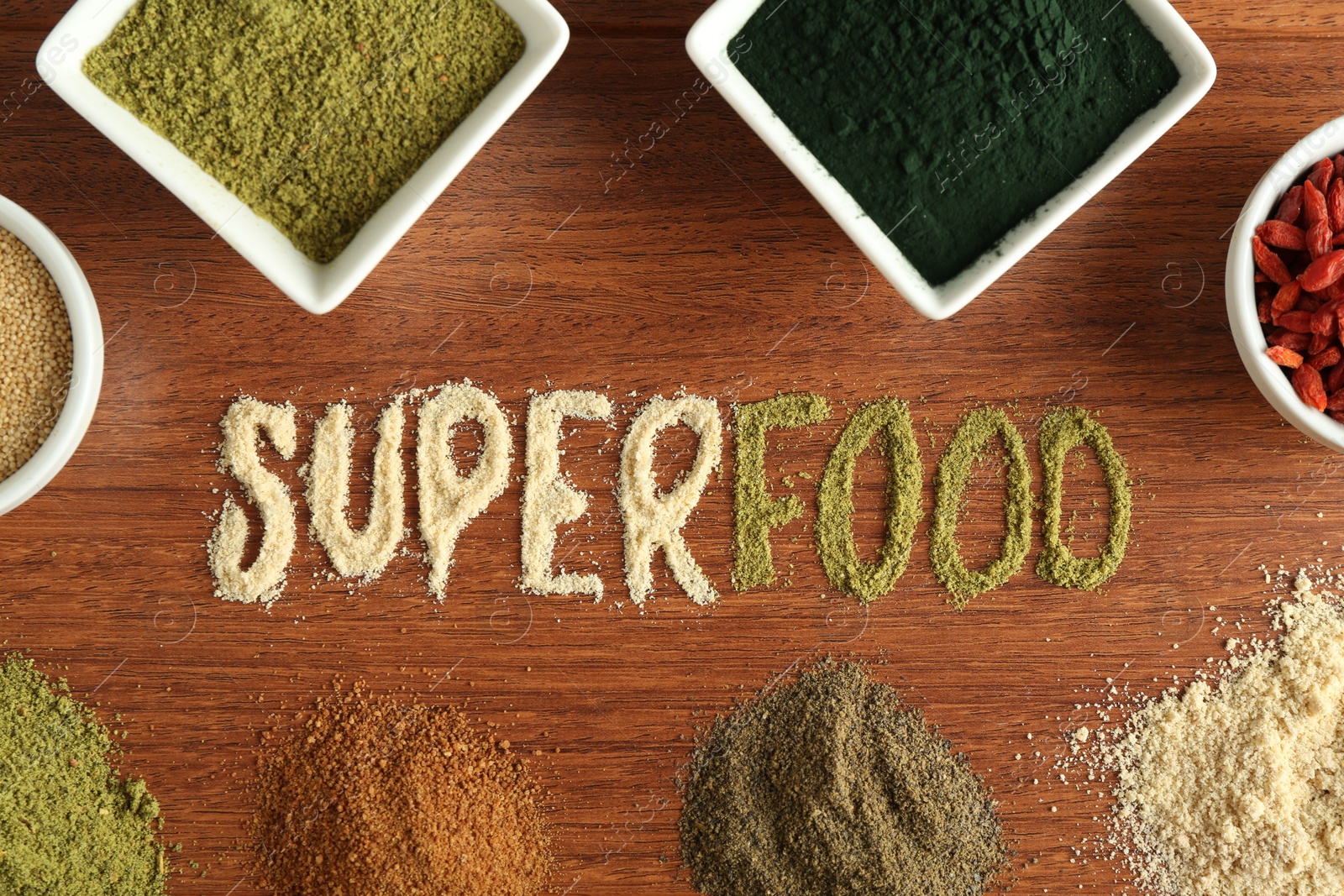 Photo of Word Superfood and different healthy powders on wooden table, flat lay