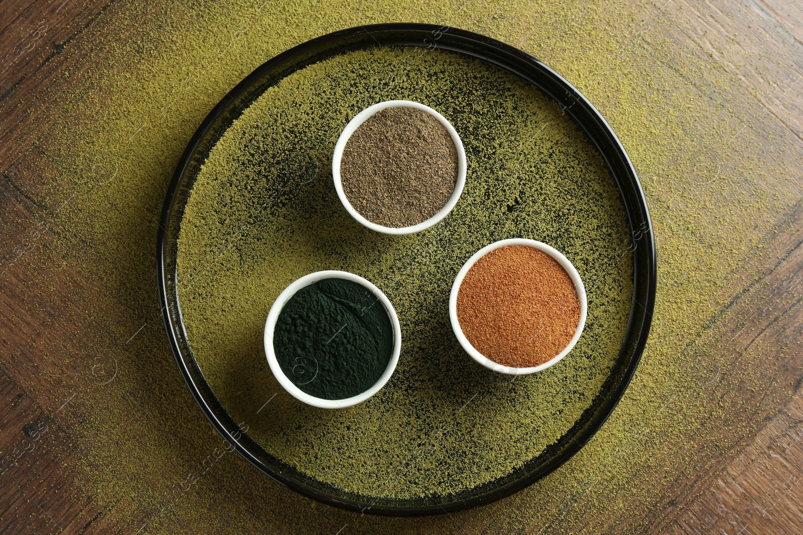 Photo of Different superfood powders in bowls on wooden table, top view