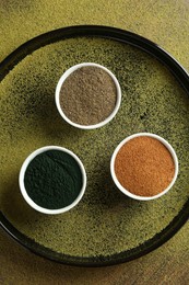 Photo of Different superfood powders in bowls on table, top view