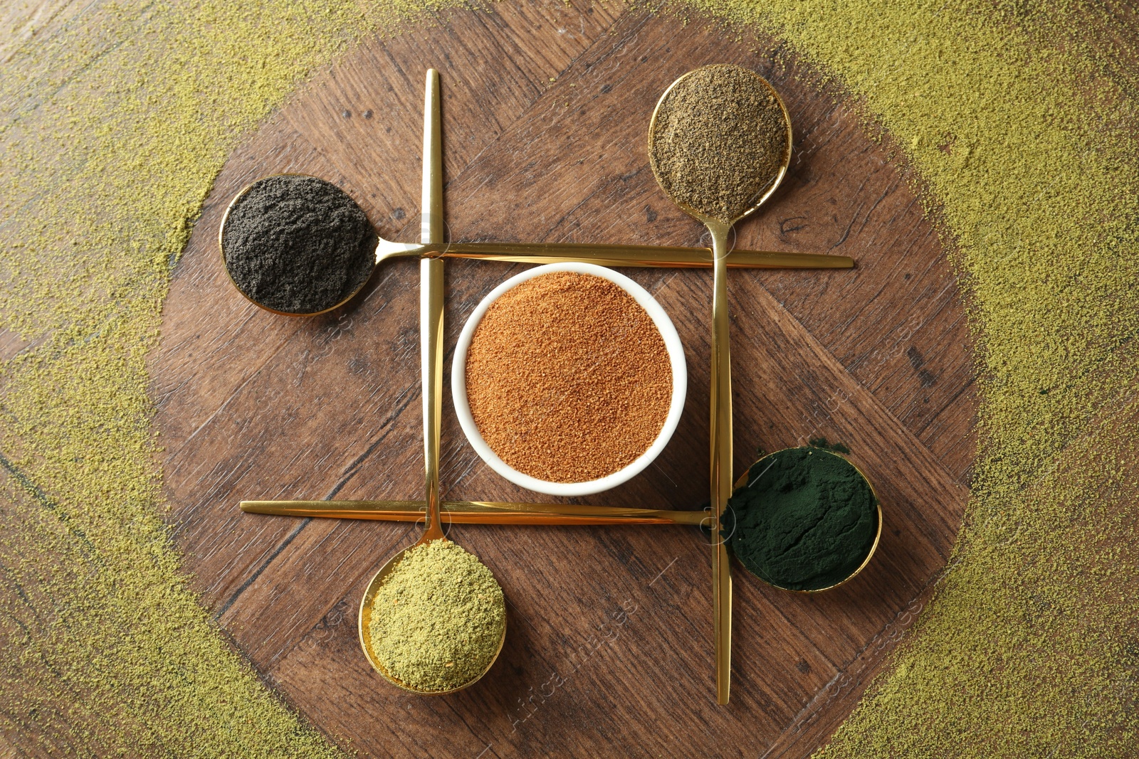 Photo of Different superfood powders on wooden table, flat lay